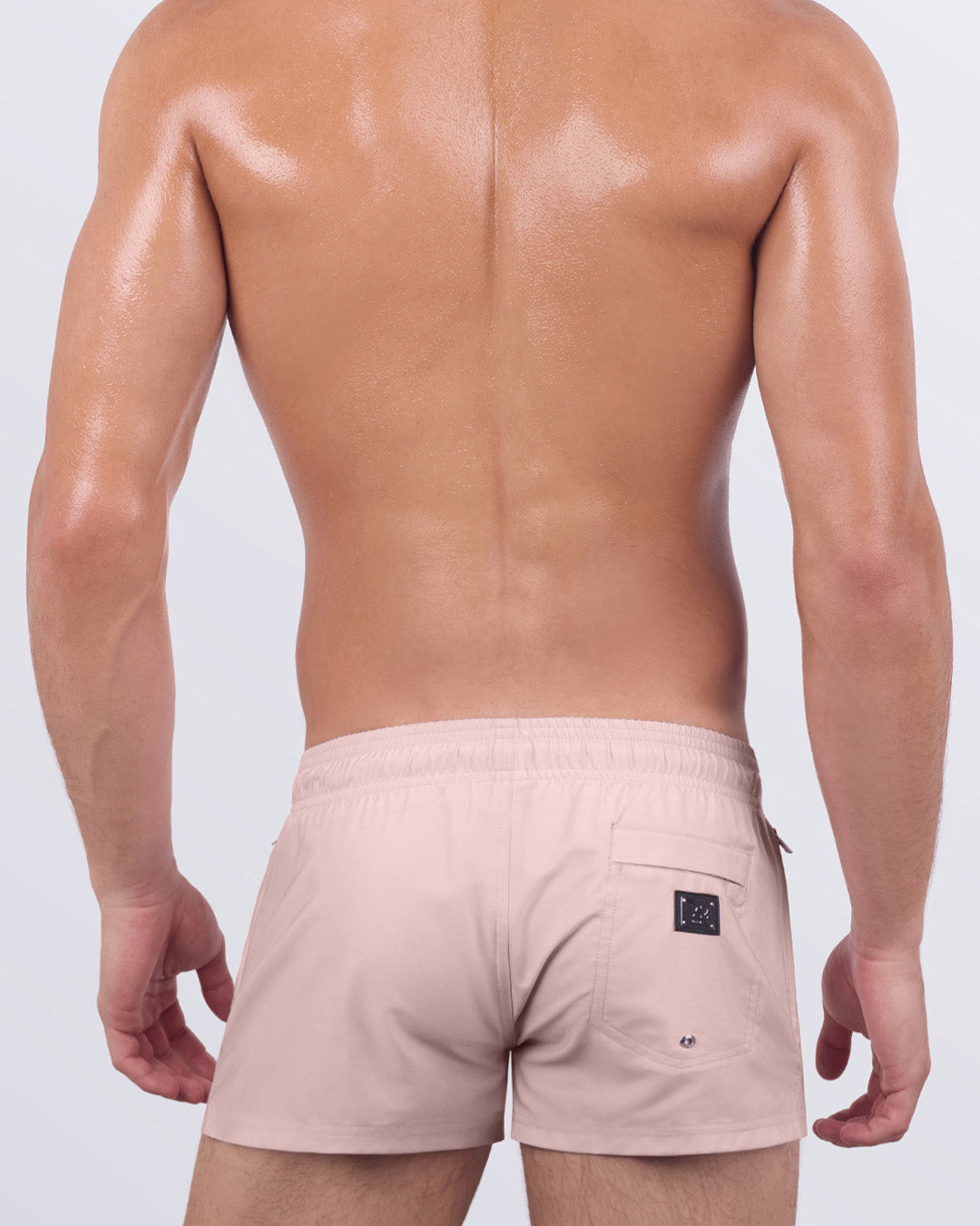 Back view of SKINNY DIP poolside shorts showcasing the rear zip pocket and subtle metallic hardware. A sleek, minimalist design for effortless summer comfort.