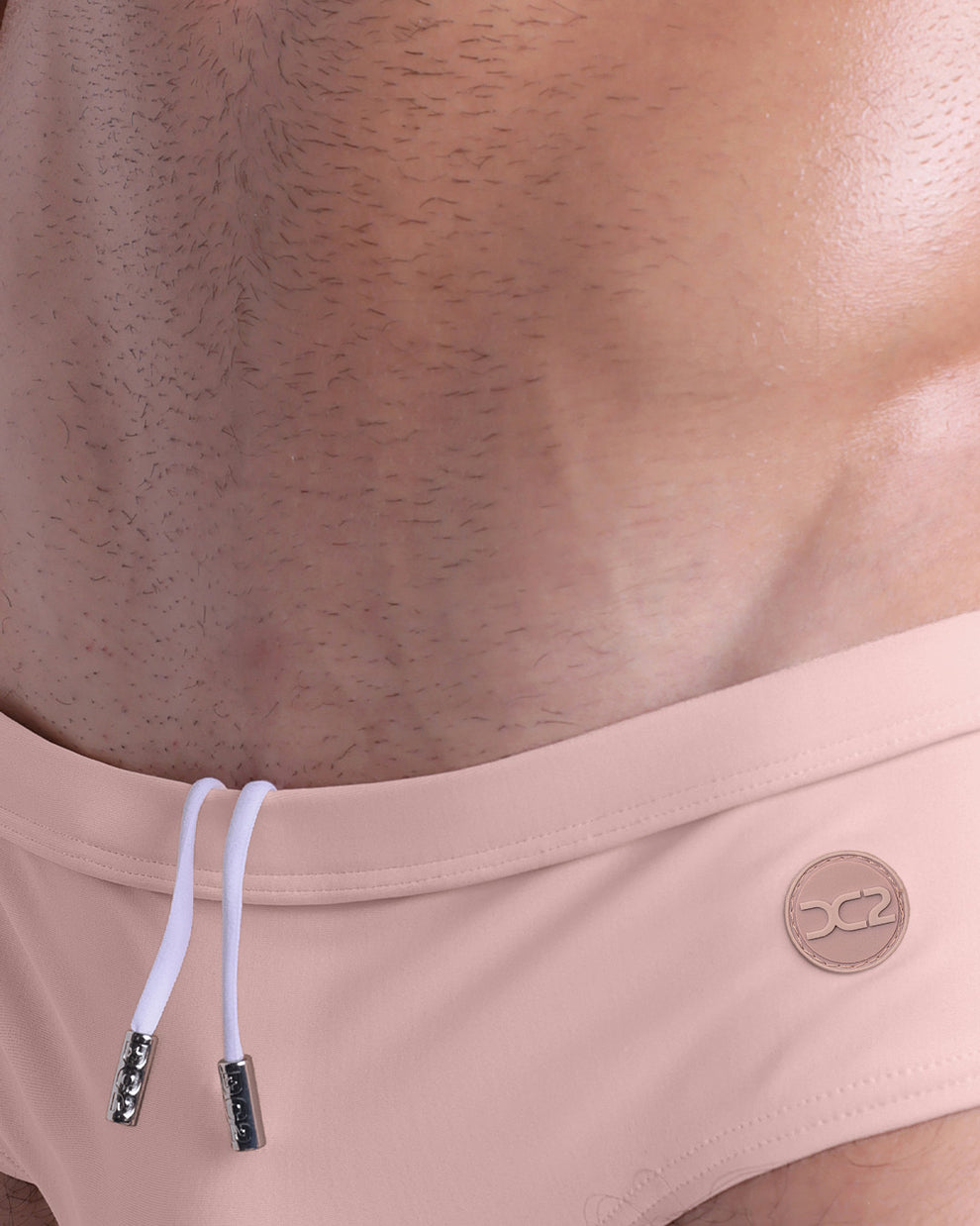 DC2 Skinny Dip (Fair/Naked Pink) Swim Brief — close-up of logo and waistband detail with inner drawstring cord.