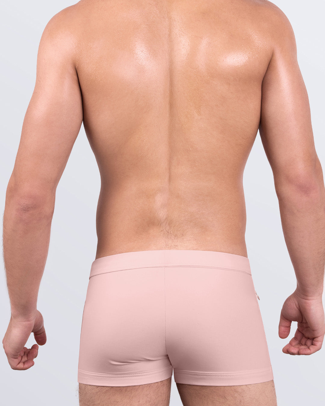 DC2 SKINNY DIP (FAIR) Swim Trunks — back view showing minimal seams and contoured fit in blush pink shade.