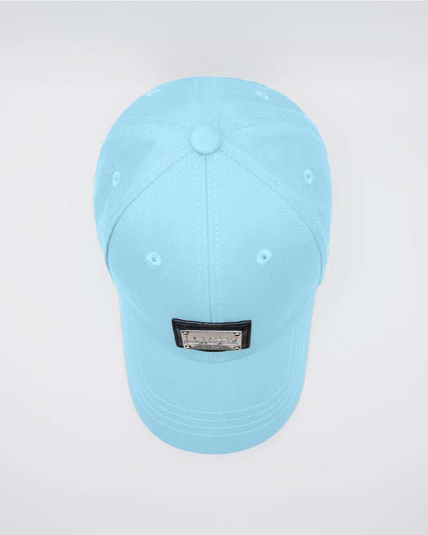 Close-up of a SKY BLUE Baseball Cap with polished DC2 metallic silver plaque. Features ventilation eyelets on the cap to provide extra breathability, perfect for active wear.