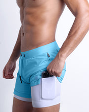 Side view of men’s triaining  in a solid light sky blue color with interior compression phone pocket made made by DC2 the official brand of mens sportswear.