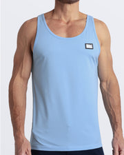 Frontal view of male model wearing the SKY BLUE in a bright, clear sky blue color casual gym tank top for men by the DC2 brand of men's beachwear from Miami.