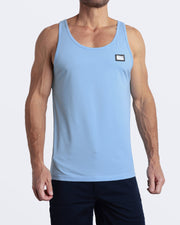 A model wearing the SKY BLUE men's fitness breathable tank top with the BLOOMING BLUE Street Shorts. The casual beach tank top is made of modal cotton blend in a solid light pastel blue color by DC2 Miami menswear.