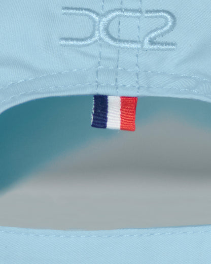 Back detail of the DC2 Resort Cap in Sky Blue — featuring tonal stitching and a woven tricolor accent tab.
