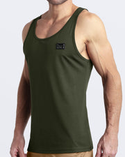 Side view of men’s workout tank top in SLICK GREEN a military green color with a metallic plaque logo made by DC2 Clothing the new official brand of mens beachwear.