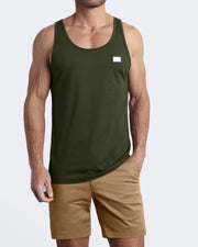 A model wearing the SLICK GREEN men's fitness breathable tank top with the SAFARI BROWN Street Shorts. The casual beach tank top is made of modal cotton blend in a green color by DC2 Miami menswear.