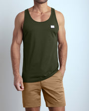 A model wearing the SLICK GREEN men's fitness breathable tank top with the SAFARI BROWN Street Shorts. The casual beach tank top is made of modal cotton blend in a green color by DC2 Miami menswear.