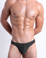 DC2 Slim Green Swim Mini Brief — model wearing low-rise men’s swim mini brief with sculpted front pouch and minimal coverage.