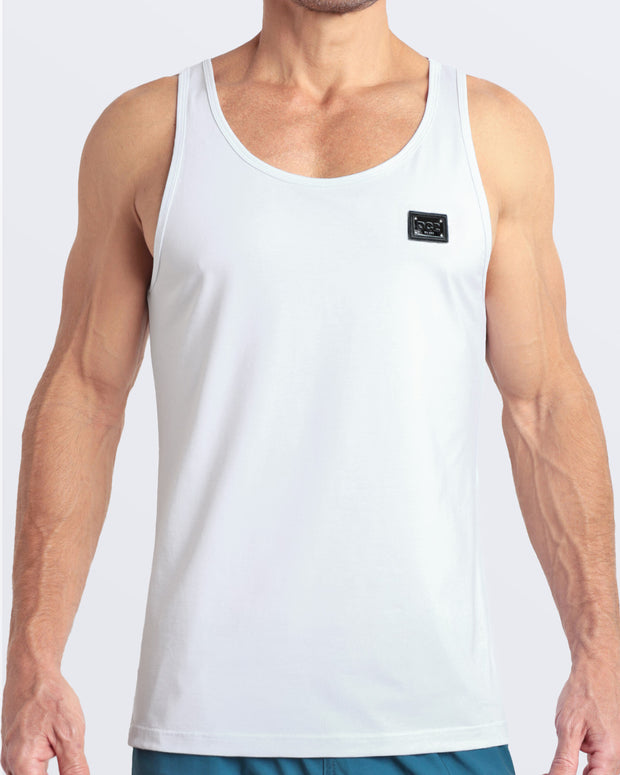 Frontal view of male model wearing the SOFT WHITE in a solid white color casual gym tank top for men by the DC2 brand of men&