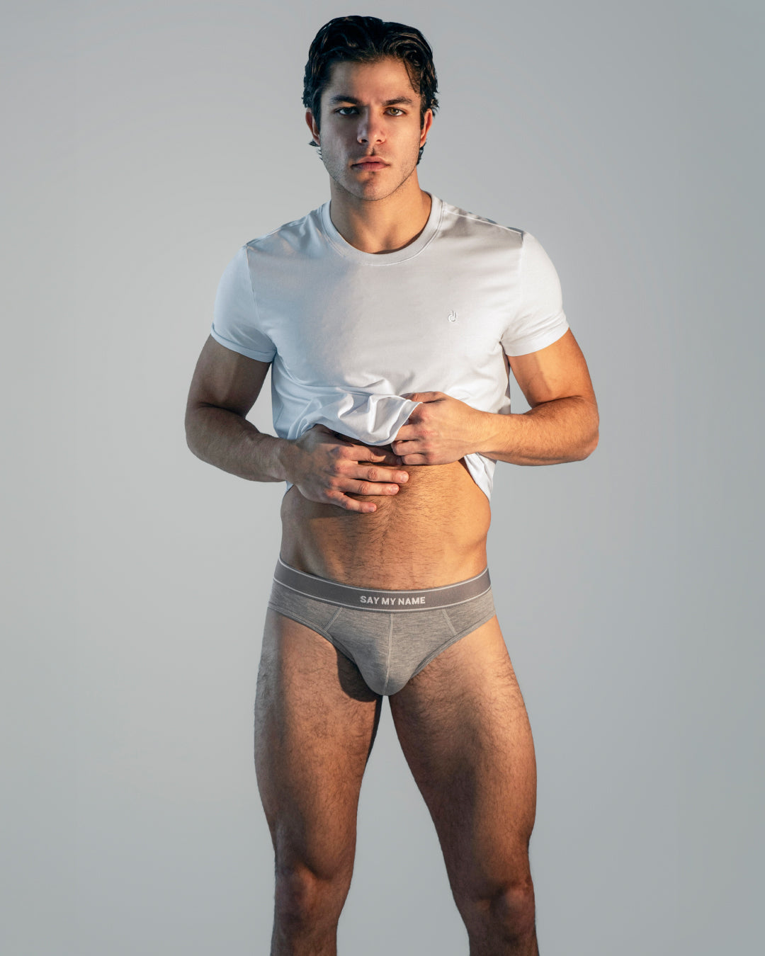 Model wearing DC2 Soft White Modal Cotton T-Shirt and Say My Name Modal Briefs, standing against a neutral background, showcasing a sleek, modern, and minimal underwear look.