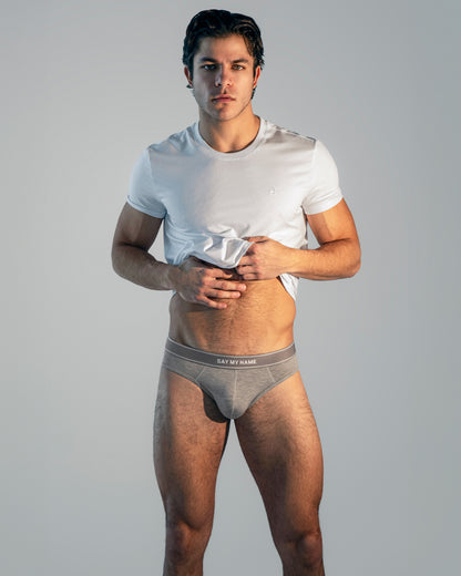 Model wearing DC2 Soft White Modal Cotton T-Shirt and Say My Name Modal Briefs, standing against a neutral background, showcasing a sleek, modern, and minimal underwear look.