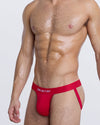 DC2 SOME LIKE IT HOT Jockstrap — side angle showing fit and supportive strap design in vivid red.