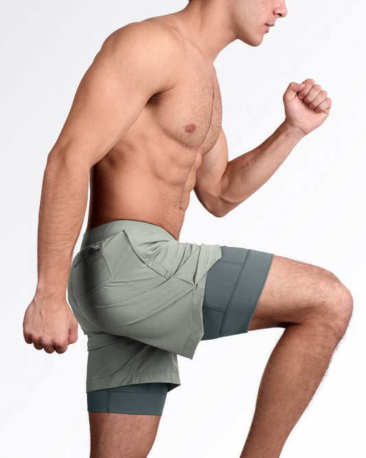Lateral view of man wearing lined gym workout shorts in gray color from DC2 Miami fitness menswear.