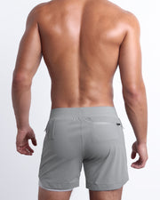 Back view of the SPACE GRAY men's fitness compression lined workout shorts in a grey color. These premium quality quick-dry endurance shorts are DC2 by BANG! Clothes, a men’s beachwear brand from Miami.