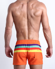 Back view of model wearing Stripe'A'Pose REMIX men’s swimwear by the Bang! Clothes brand of men's beachwear from Miami.