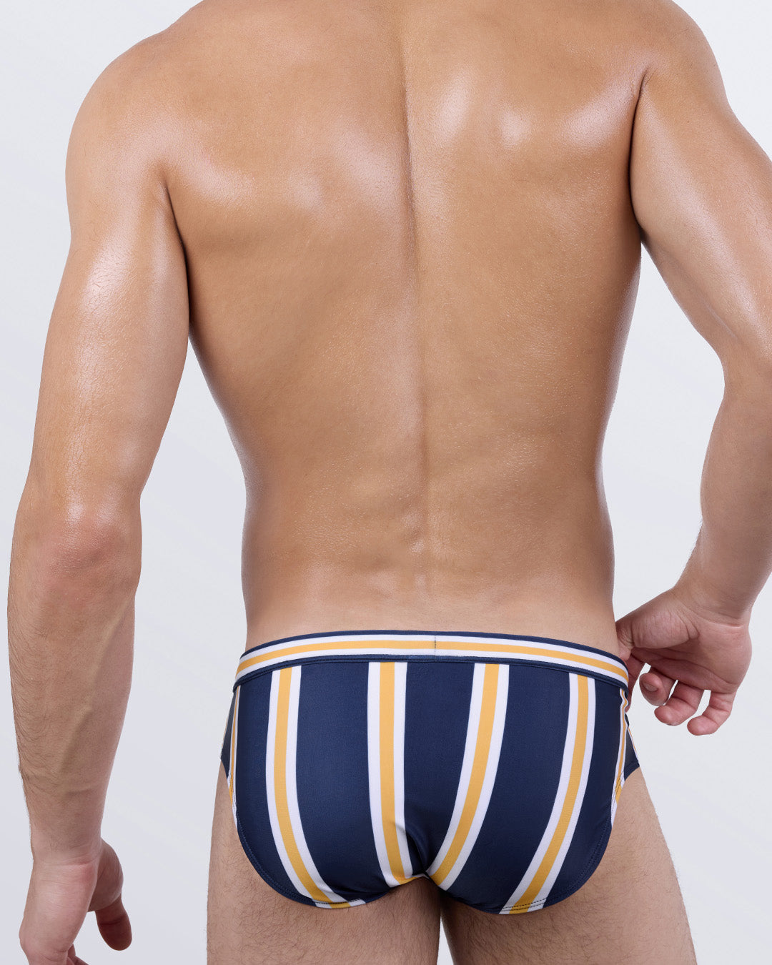 Back of SUN CHASING STRIPES Swim Brief by DC2 Miami – navy striped men's swimsuit with supportive fit and contoured silhouette.