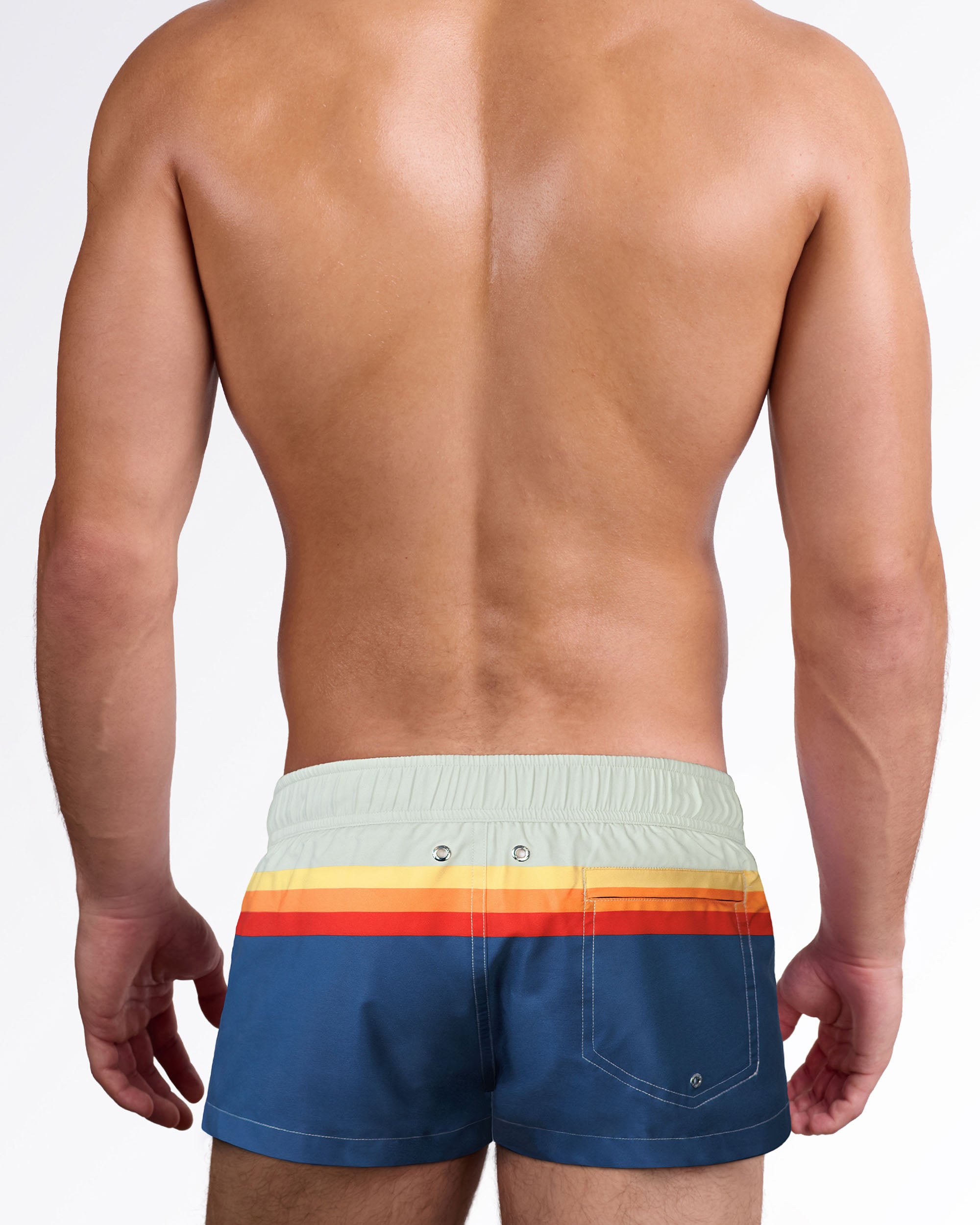 Back view of Sunset Stripes Mini Shorts showcasing the retro stripe design wrapping around the waist, rear pocket, and tailored swim silhouette.