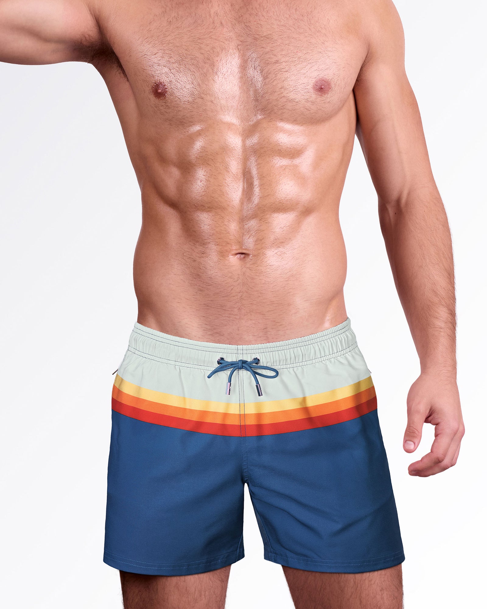 Sunset Stripes Resort Shorts by DC2 Miami featuring retro-inspired orange, yellow, and red stripes on a deep blue body with an adjustable drawstring waist.
