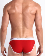 Back view of model wearing the SUPERB RED from the Retro line Men’s breathable cotton briefs in a red color for men by BANG! Offers light compression for perfect contouring to the body and second-skin fit.