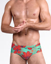 BANG Surf Flowers Aqua Red Swim Brief — front view featuring vibrant aqua base with oversized red floral print and navy line detailing, low-rise tailored silhouette.