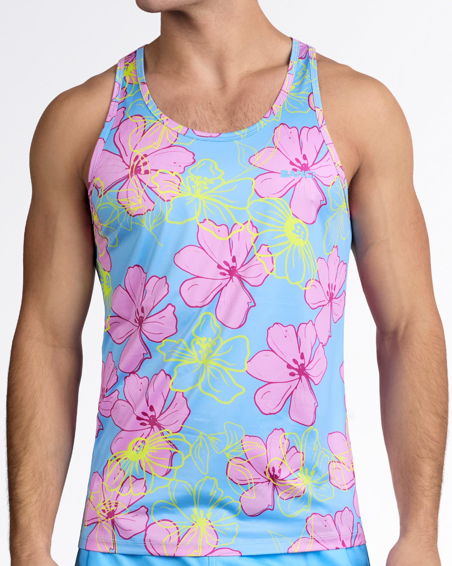 BANG Surf Flowers (Pink/Blue) Gym Tank Top — model wearing sky blue men’s tank featuring oversized pink hibiscus flowers with neon yellow outlines and subtle BANG logo at chest.