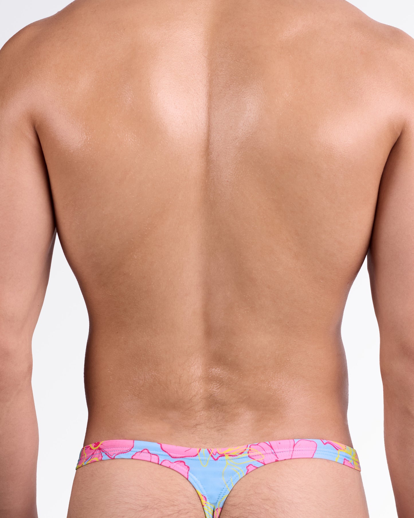BANG Surf Flowers (Pink/Blue) Swim Thong — back view showcasing minimal thong cut, slim waistband, and vibrant tropical floral pattern.