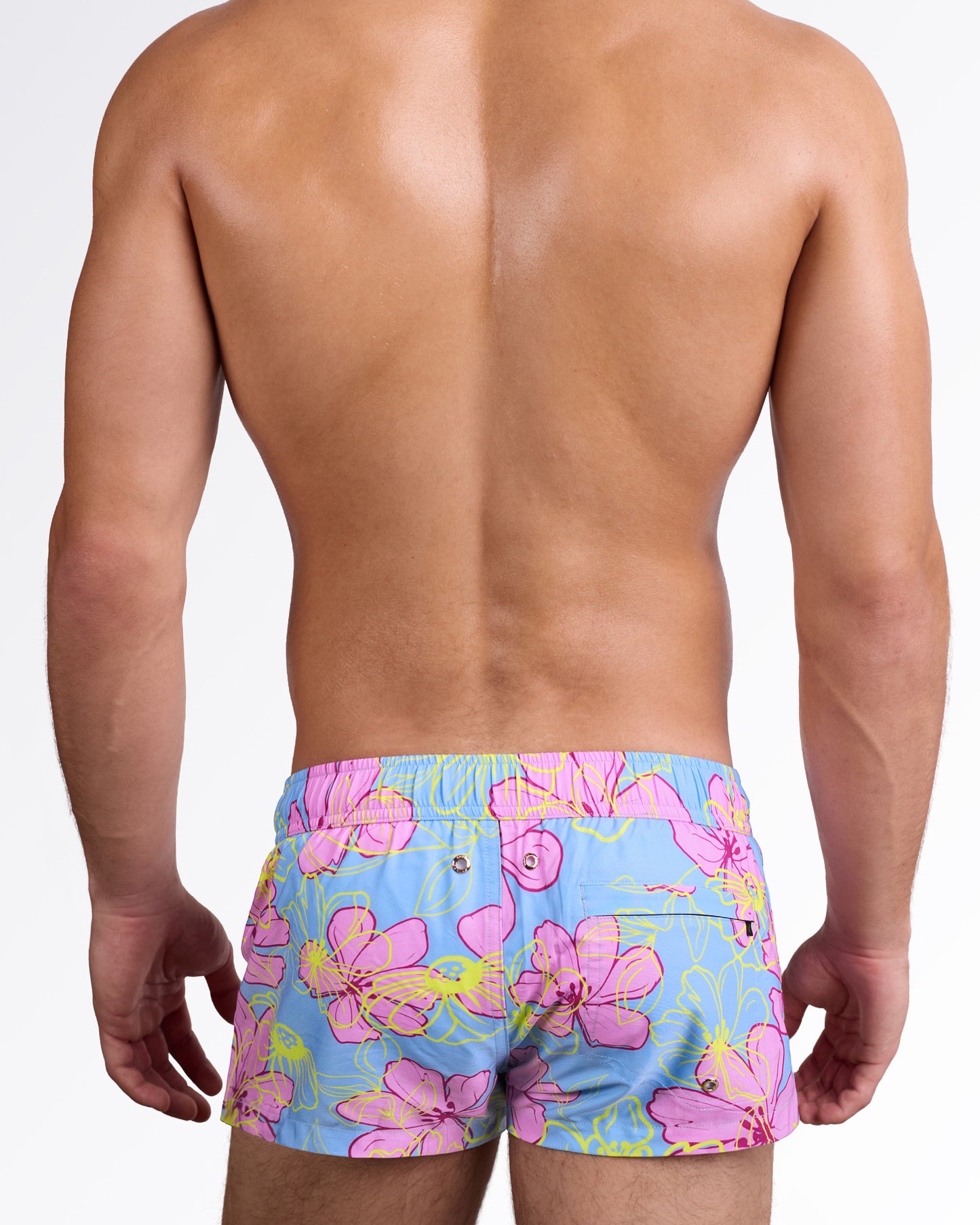 BANG Surf Flowers (Pink/Blue) Mini Swim Shorts — back view showcasing the bold floral print, elastic waistband, and functional rear pocket detail for beach-ready style.