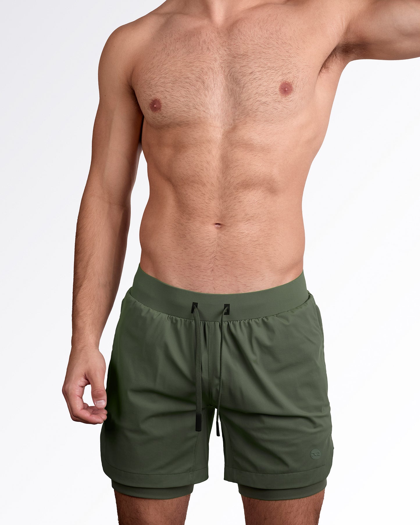 Man wearing lined gym workout shorts in military green color from DC2 Miami fitness menswear.