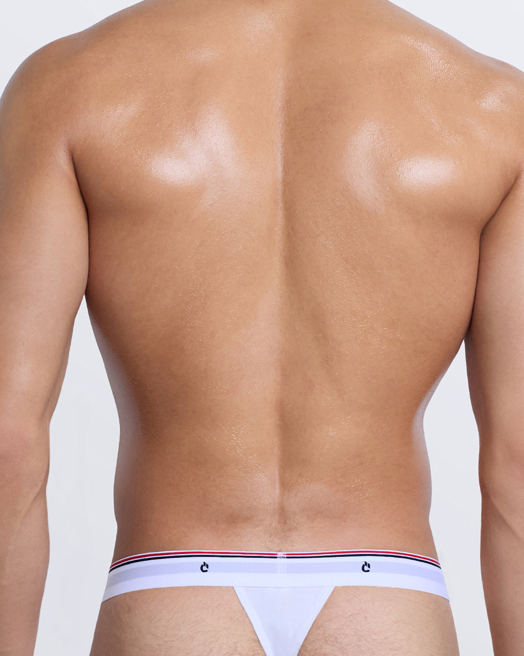 DC2 Modal Thong — back view on model featuring sleek minimal coverage and branded waistband in white.
