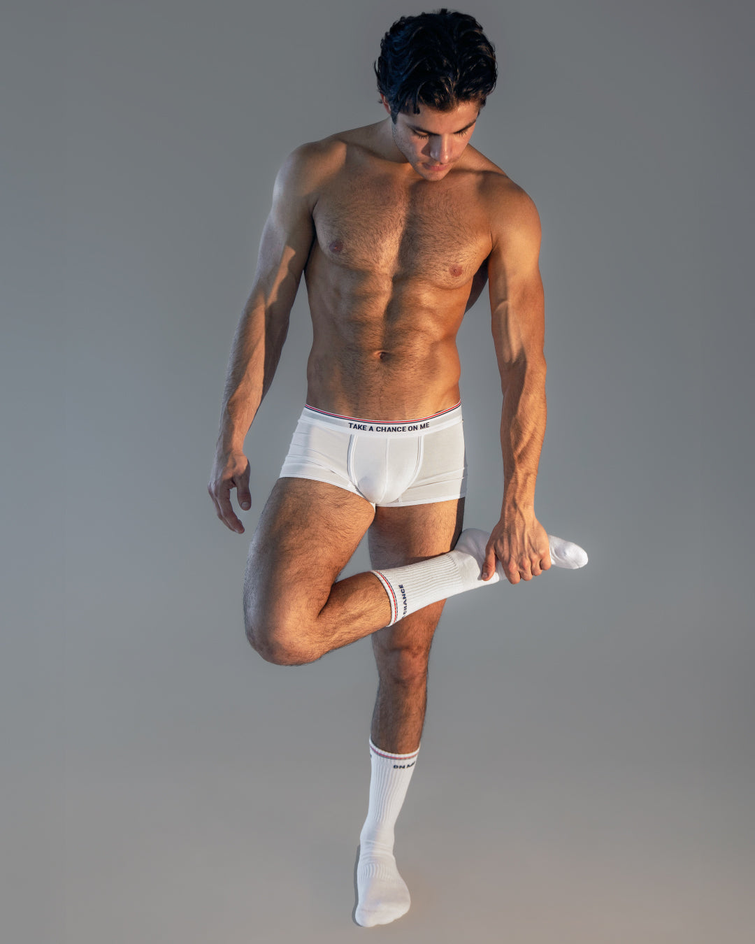 Model wearing DC2 Take My Breath Away Modal Boxer Briefs and matching socks, standing in a minimal studio setting, showcasing the sleek white fabric and modern fit.