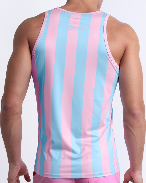 Back view of a male model wearing men’s THE KEN (IBIZA EDITION) beach quick-dry tank top by BANG! Clothes in Miami, featuring pastel pink and blue colored stripes. 