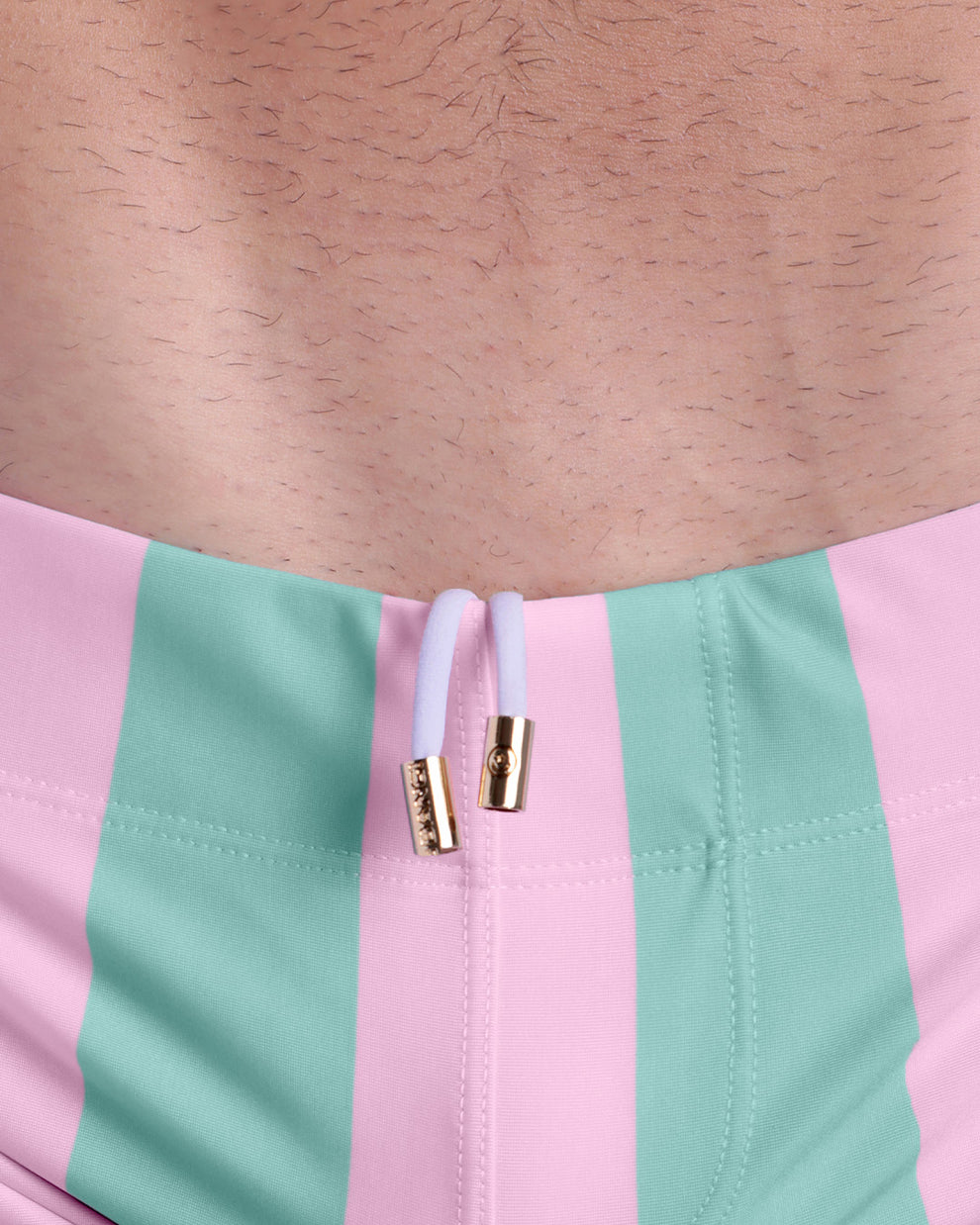 Close-up view of men’s summer beach shorts by BANG! clothing brand, showing white cord with custom branded golden cord ends, and matching custom eyelet trims in gold.