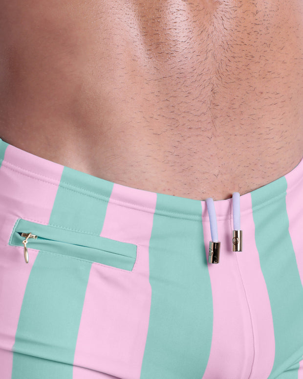 Close-up view of the THE KEN (MALIBU EDITION) Swim Sunga mens swimsuit with white internal drawstring cord showing custom branded golden buttons and a mini zippered pocket by BANG! clothing brand.