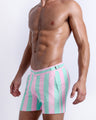 Side view of the THE KEN (MALIBU EDITION) for men’s summer Tailored Shorts with dual pockets. Inspired by the Barbie movie SoBe/Art-Deco-pastels in pink and pastel aqua green stripes, these shorts are designed by BANG! Clothes in Miami.