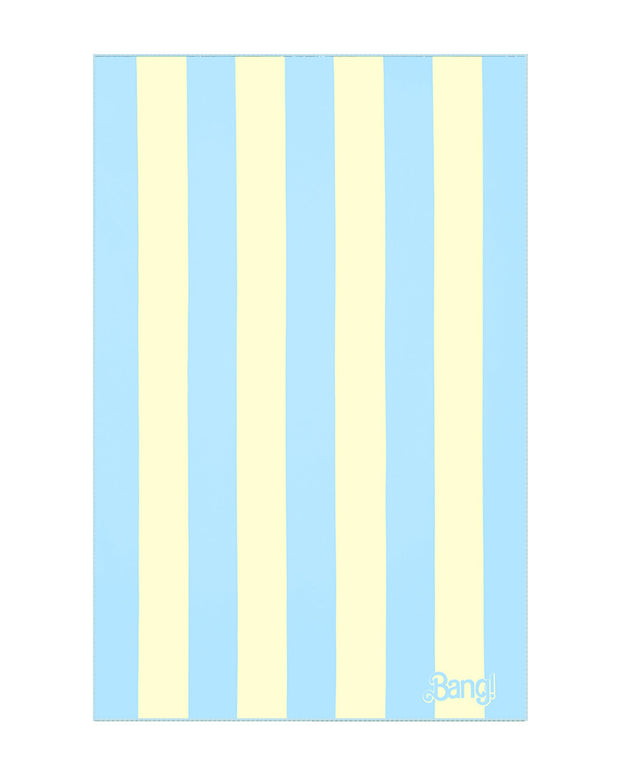 An image of The Ken (Miami Edition) hyper-absorbent microfiber beach towel. The soft towel features a striped design with pastel yellow and light-blue colors and the BANG! logo in the bottom right corner.