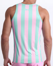 Back view of a male model wearing men’s THE KEN (MALIBU EDITION) beach quick-dry tank top by BANG! Clothes in Miami, featuring pastel pink and aqua-colored stripes. 