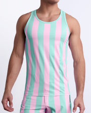 Male model wearing THE KEN (MALIBU EDITION) casual Tank Top, premium quality tank top in pink and light aqua-colored stripes inspired by the styles seen worn by Ryan Gosling as Ken, in the Barbie movie. Designed by BANG! Clothes, a men’s beachwear brand from Miami.