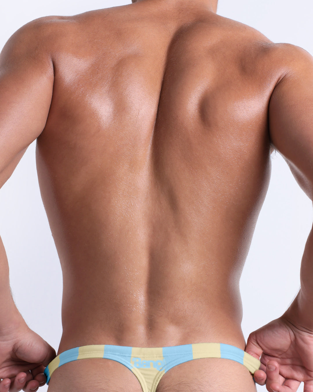 Man wearing colorful underwear on a plain background