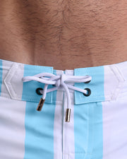Close-up view of inseam and details of THE KEN (MYKONOS EDITION) shorts for men, with a sky blue color cord and custom branded golden cord-ends, and matching custom eyelet trims.