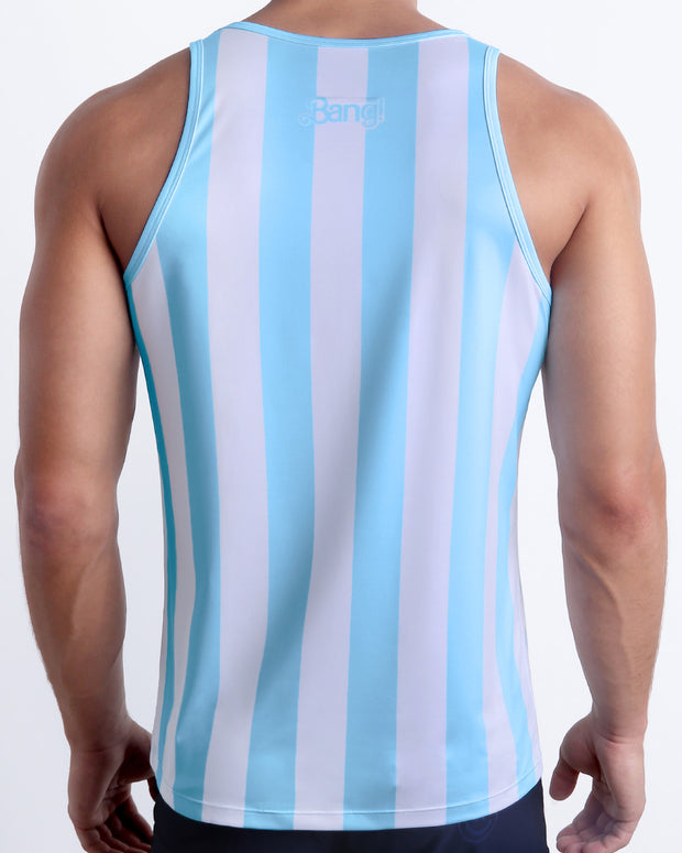 Back view of a male model wearing men’s THE KEN (MYKONOS EDITION) beach quick-dry tank top by BANG! Clothes in Miami, in white and light blue-colored stripes inspired by the styles seen worn by Ryan Gosling as Ken, in the Barbie movie.