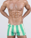 Front view of THE KEN (TULUM EDITION) Swim Trunks – bold green-and-cream vertical stripes with signature BANG! logo and a sleek low-rise cut.