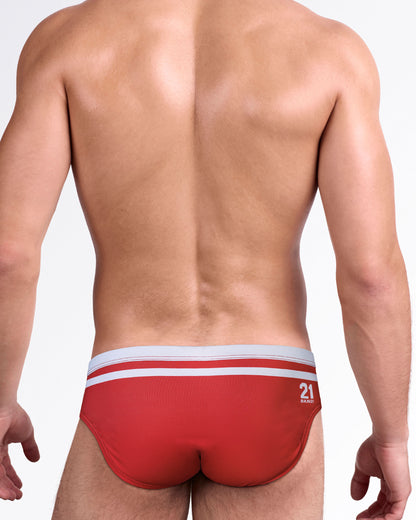 BANG Heated Rivalry Scott Swim Brief — back view showcasing the red swim brief, contrast waistband stripes, and numbered detail.