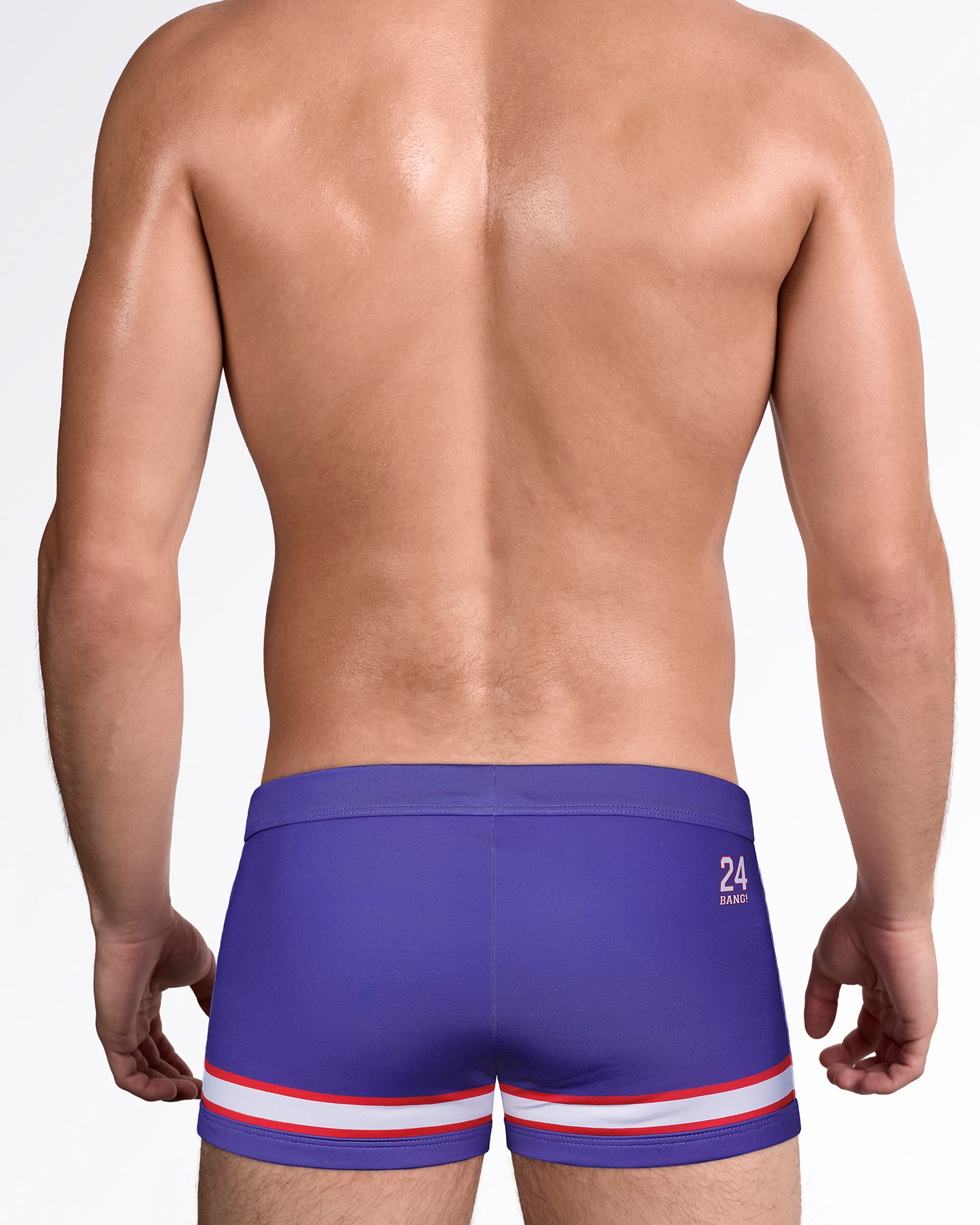 Back view of The Shane Swim Trunks showcasing the sleek square-cut fit, contrast stripe hem, and premium men's swimwear design with back logo detail.