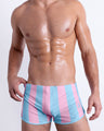 Front view of THE KEN (IBIZA EDITION) men’s sexy bottoms with light pink and sky blue colored stripes inspired by the style as seen worn by Ryan Gosling as Ken, in the Barbie movie. This premium quality swimwear is by BANG! Clothes, a men’s beachwear brand from Miami.