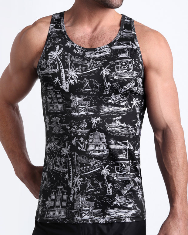 Front view of model wearing the TOILE DE MIAMI (BLACK) men’s beach casual cotton tank top in black with white Toile De Jouy art by the Bang! Clothes brand of men&