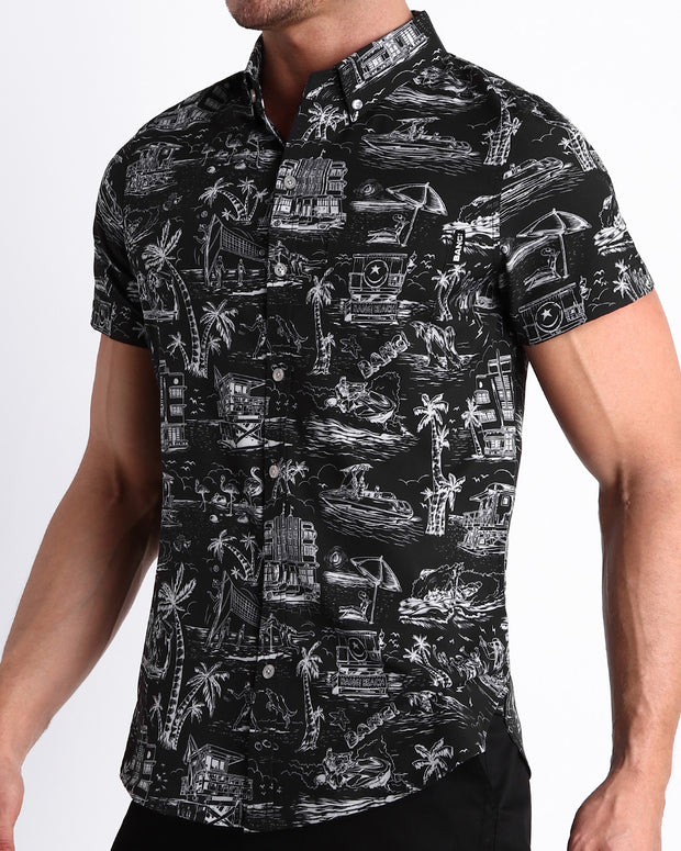 Side view of the TOILE DE MAIMI (BLACK) men’s Summer button down in black with white art with front pocket by Miami based Bang brand of men&