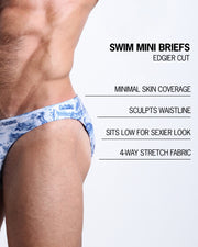 Infographic explaining the features of the TOILE DE MIAMI (BLUE) Swim Mini Brief made by BANG! Clothes. These edgier cut mens swimsuit are minimal skin coverage, sculpts waistline, sits low for sexier look, and 4-way stretch fabric.