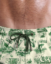 Close-up view of inseam and details of TOILE DE MIAMI (GREEN) swimsuit for men, with green color cord and custom branded golden cord-ends, and matching custom eyelet trims in gold.