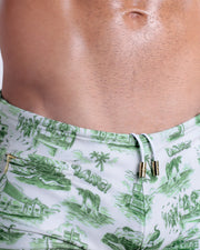 Close-up view of the TOILE DE MIAMI (GREEN) men’s drawstring briefs showing white cord with custom branded golden cord ends, and matching custom eyelet trims in gold.