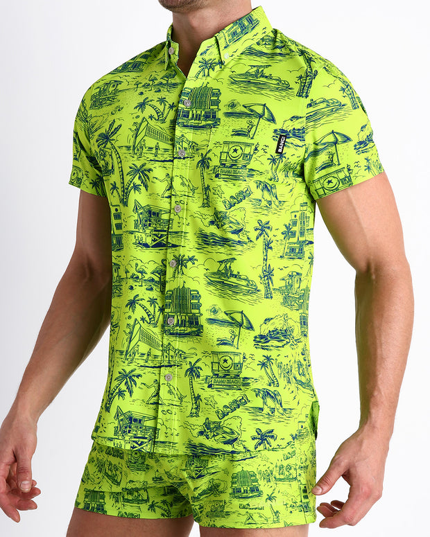 Side view of the TOILE DE MAIMI (NEON GREEN/BLUE) men’s Summer button down in bright neon green with navy blue art with front pocket by Miami based Bang brand of men&